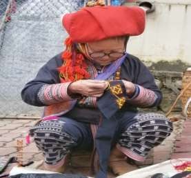 Hình 8 Cô C S M người Dao đỏ vừa bán hàng vừa thêu hoa văn để tạo sản phẩm 8